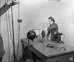 WAAF technician operating a 16mm Bell and Howell rostrum camera, RAF Bentley Priory, London, England, United Kingdom, Dec 1943