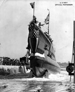 Submarine Tinosa, adorned with flags and bunting, sliding down the ways at Mare Island Navy Yard, Vallejo, California, United States, 7 Oct 1942.