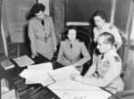 Squadron Officer M. S. Philip speaking to WAAF director Air Chief Commandant Mary Welsh with RAF Mediterranean and Middle East chief Air Marshal Guy Garrod at Garrod