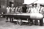 Seven United States Navy officers and one Chief Petty Officer pose with the station’s first Mark XIV torpedo at the Naval Torpedo Station at Keyport, Washington, United States, 1943.