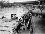 Mark XV torpedoes being transferred to the USS Nicholas from the USS Patterson at Tulagi, Solomon Islands, 13 Jul 1943 following the Battle of Kolombangara. Photo 1 of 2.