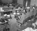 WAAF personnel transposing morse tape into plain language (foreground) and vice versa (further to the right) at Headquarters No. 60 (Signals) Group, RAF Leighton Buzzard, Bedfordshire, England, United Kingdom, date unknown