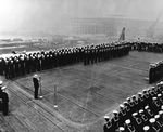Chaplain offering the invocation at the commissioning ceremonies for auxiliary aircraft carrier USS Bogue at Bremerton, Washington, United States, 26 Sep 1942. Note Bogue’s forward elevator.