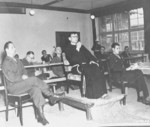 Father Lelere, a former prisoner of Flossenbürg Concentration Camp, testifying at the trials of former camp personnel, Dachau Concentration Camp, Germany, 21 Jun 1946; note court interpreter Fred Stecker at right