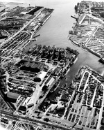 Aerial view of Permanente Metals Shipyard No. 1 looking south into San Francisco Bay, Richmond, California, United States, 11 Dec 1944. Note the prefabrication shed on the left and the large Ford assembly plant at top.