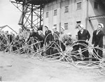 United States Navy sailors gathering partially completed submarine netting made from steel cables, Tiburon Naval Net Depot, Tiburon, California, United States, Apr 1941.
