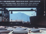 View of Mt. Tamalpais seen through the Plate Shop at the Marinship Shipbuilding yard, Sausalito, California, United States, 1944-45. Marinship flagship, USS Tamalpais, was named for this mountain.
