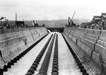Water flows into Pearl Harbor Drydock No. 1 for the first time on 21 Aug 1919, Pearl Harbor, Hawaii. The dock was flooded with the push of a button from Mrs. Josephus Daniels, wife of the Secretary of The Navy.
