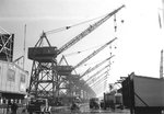 Gantry cranes, one each for the fourteen shipways, at the CalShip yard, Los Angeles, California, United States, 1944.