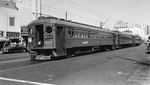 Pacific Electric streetcars (the Red Cars) waiting on Ocean Blvd, Long Beach, California, United States, Apr 1945. These cars are labeled “CalShip Special” and are waiting for shipyard workers.