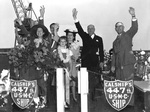The christening party waves as the Rice Victory slides down the ways, 16 Jun 1945, CalShip, Los Angeles, California, United States.