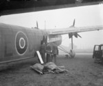 Medical orderlies loading wounded servicemen onto a Harrow aircraft of No. 271 Squadron RAF, RAF Hendon, London, England, United Kingdom, 1940s