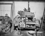 A Light Tank Mk VI receiving engine repair work on its engine at a British Royal Army Service Corps workshop, France, 3 Jan 1940