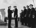 Captain R. W. Christi presenting the Navy Cross to Lieutenant Irvin S. Hartman of USS S-41, Sep 1942