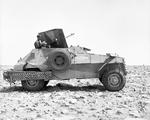 A Marmon-Herrington Armored Car at Tobruk, Libya, 8 May 1941. Note the Italian Breda Model 35 anti-aircraft gun mounted on the top and the steel wheel ramps hanging over the rear wheels.