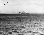 USS St. Louis immediately after being struck by a Japanese special attack aircraft abaft the No. 5 gun turret, Leyte Gulf, 27 Nov 1944. The photo was taken from the battleship USS West Virginia.