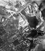 Allied photograph of Kriegsmarinewerft shipyard and surrounding areas in Wilhelmshaven, Germany, 30 Aug 1940; the shipyard was easily identified by the square construction basin at lower left, and the large body of water to the right was to be a new construction shipyard named Nordwerft (North Yard)