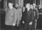 Adolf Hitler (foreground), Pál Teleki (foreground), Galeazzo Ciano (behind Hitler), Saburo Kurusu (behind Ciano), and others at the ceremony in which Hungary signed the Tripartite Pact, Vienna, Austria, 20 Nov 1940