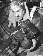 Tail gunner on a Martin B-26 Marauder with the 386th Bomb Group taking his position with a Fairchild K-20 aerial camera, 1944.