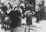 A Jewish boy and other civilians being rounded up by German troops, during the Warsaw Ghetto Uprising, Warsaw, Poland, between 19 Apr 1943 and 16 May 1943