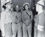Chester Nimitz, William Halsey, Oscar Badger, and Edwin Layton listening to Japanese doctor Y. Kimura during a tour of Yokosuka naval hospital, 30 Aug 1945. The hospital had been converted to treat Allied POWs.