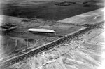 German airship Graf Zeppelin seen moored to a temporary mooring mast at Mines Field, Inglewood, California after arriving from Japan on her around-the-world flight, 26 Aug 1929. Photo 2 of 3.