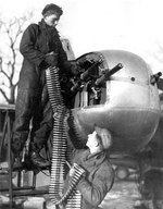 Two crew members loading ammunition for their A-26 bomber