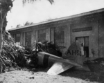 Wreckage of a Japanese A6M2 Zero fighter at Buliding 52 (Ordinance Machine Shop) at Fort Kamehameha, US Territory of Hawaii, 7 Dec 1941; the fighter was flown by Petty Officer 1st Class Takeshi Hirano