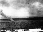 Japanese A6M2 Zero fighter flying above a shot-down US fighter, near Ewa Marine Corps Air Station, Oahu, US Territory of Hawaii, 7 Dec 1941; photo taken by a B-17 bomber crew