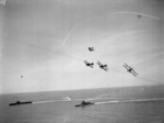 Albacore aircraft of No. 820 Squadron FAA flying in formation over HMS Formidable and other warships, 1940s