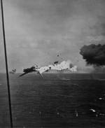 A B6N2 torpedo bomber exploding in mid-air after direct hit by 5-inch shell from carrier Yorktown, off Kwajalein, Marshall Islands, 4 Dec 1943, photo 1 of 2