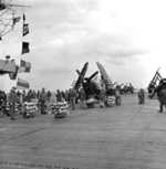 F4U-4B Corsair fighters of US Marine Corps squadron VMF-323 being equipped with 12.7cm napalm canisters and HVAR rockets aboard USS Badoeng Strait off Korea, 1 Dec 1950