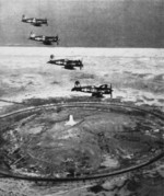 F4U-4 Corsair fighters of US Marine Corps squadron VMF-212 in flight over Wright Memorial, Kitty Hawk, North Carolina, United States, 17 Dec 1948; seen in Feb 1949 issue of US Navy publication Naval Aviation News
