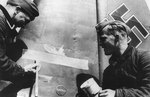 Painting a submarine kill marking on the tail of a He 111 bomber, circa 1939-1944