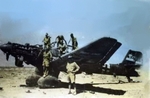 Australian soldiers on a wrecked German Ju 87B Stuka dive bomber, Libya, circa 1941