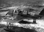 OS2U Kingfisher aircraft recovered alongside battleship Arizona, near US Territory of Hawaii, 6 Sep 1941, photo 1 of 2; note flag just forward of main pontoon