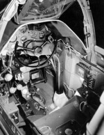 Close-up view of a P-38G Lightning aircraft cockpit, 23 Dec 1942; note the yoke rather than stick control and the bullet proof glass panel above the instrument panel. Photo 1 of 3.