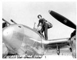 WASP pilot Ruth Dailey climbing into a P-38 Lightning aircraft, United States, 28 Nov 1944