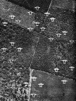A formation of P-38 Lightning aircraft of the 20th Fighter Group over France, Jun 1944