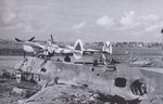 P-38J Lightning aircraft of 370th Fighter Group, US 485th Fighter Squadron at the former Luftwaffe night fighter base at Florennes, Belgium, Oct-Dec 1944; note wrecked Me 210 aircraft in foreground