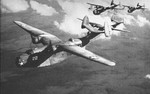 Two PBM-1 (front) and two PBM-3 (back) in flight, 1942. The PBM-1s are from an early production series with retractable floats that were discontinued for principal production. Location unknown. Photo 1 of 2