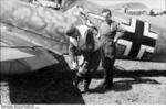 German pilot preparing for a mission in front of his Bf 109 fighter, North Africa, 1941