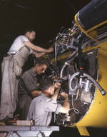 American workers making wiring assemblies at a junction box on the firewall of a B-25 bomber at the North American Aviation plant at Inglewood, California, United States, Jul 1942