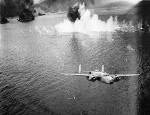 B-25D Mitchell bomber of the 13th Bomb Squadron departing Simpson Harbor after an attack, Rabaul, New Britain, 2 Nov 1943