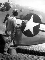 US Army African-American Staff Sergeant William Accoo, crew chief of a P-51 Mustang aircraft, washed the aircraft he was in charge of, Italy, circa Sep 1944