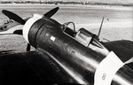 Close-up view of the front half of the fuselage of a Re.2000 Falco I fighter of the Italian 74th Squadron at rest at an airfield, date unknown