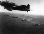 SB2U Vindicator scout bomber flying anti-submarine patrol over an American convoy en route for Capetown, South Africa, 27 Nov 1941; note cruisers Vincennes and Quincy