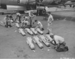 Armorers preparing propaganda leaflet canisters for loading onto a B-29 Superfortress bomber, Saipan, Mariana Islands, 1945