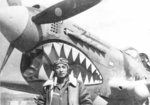 Chinese pilot Yoh Kung Chen of 27th Fighter Squadron of 5th Fighter Group of the Chinese-American Composite Wing (Provisional) with his P-40 Warhawk fighter, China, 1943-1945