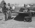 Ground crew checking the radio of a P-40 Warhawk fighter at a US 14th Air Force Base in China, May 1945; note Chinese Air Force roundel
